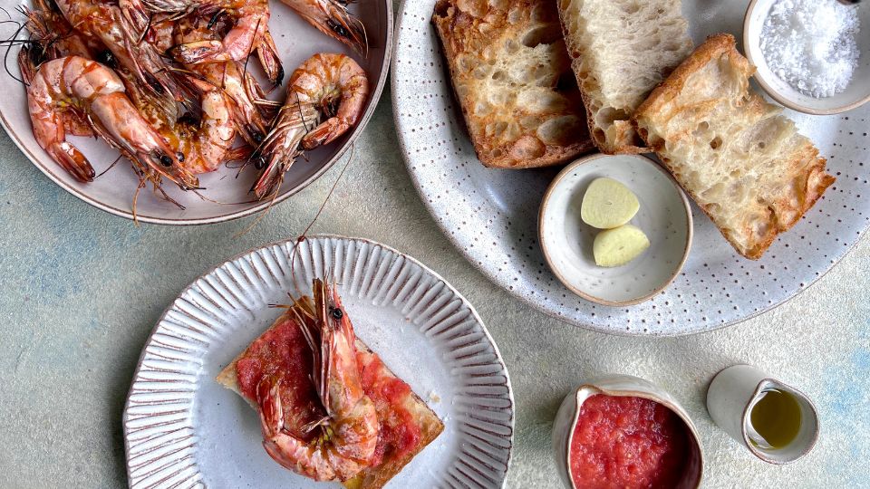 Spanish pan con tomate ( bread with grated tomato on top )and shrimps on the side