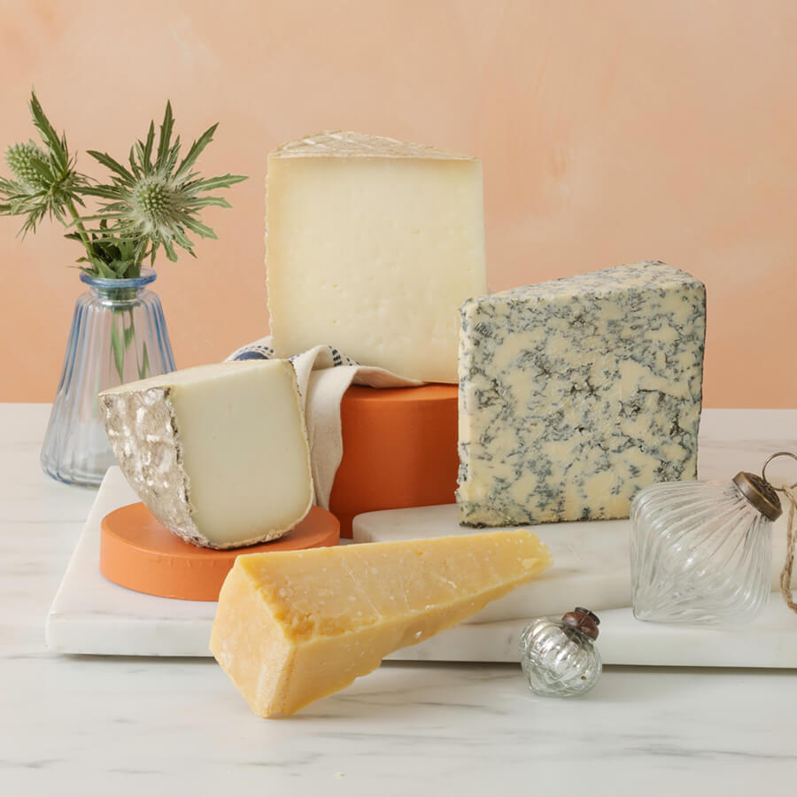 A cheese selection of garrotxa, galmesan, zamorano and mama marisa, on a marble board