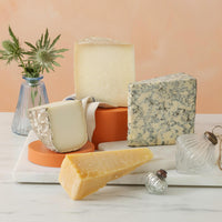 A cheese selection of garrotxa, galmesan, zamorano and mama marisa, on a marble board