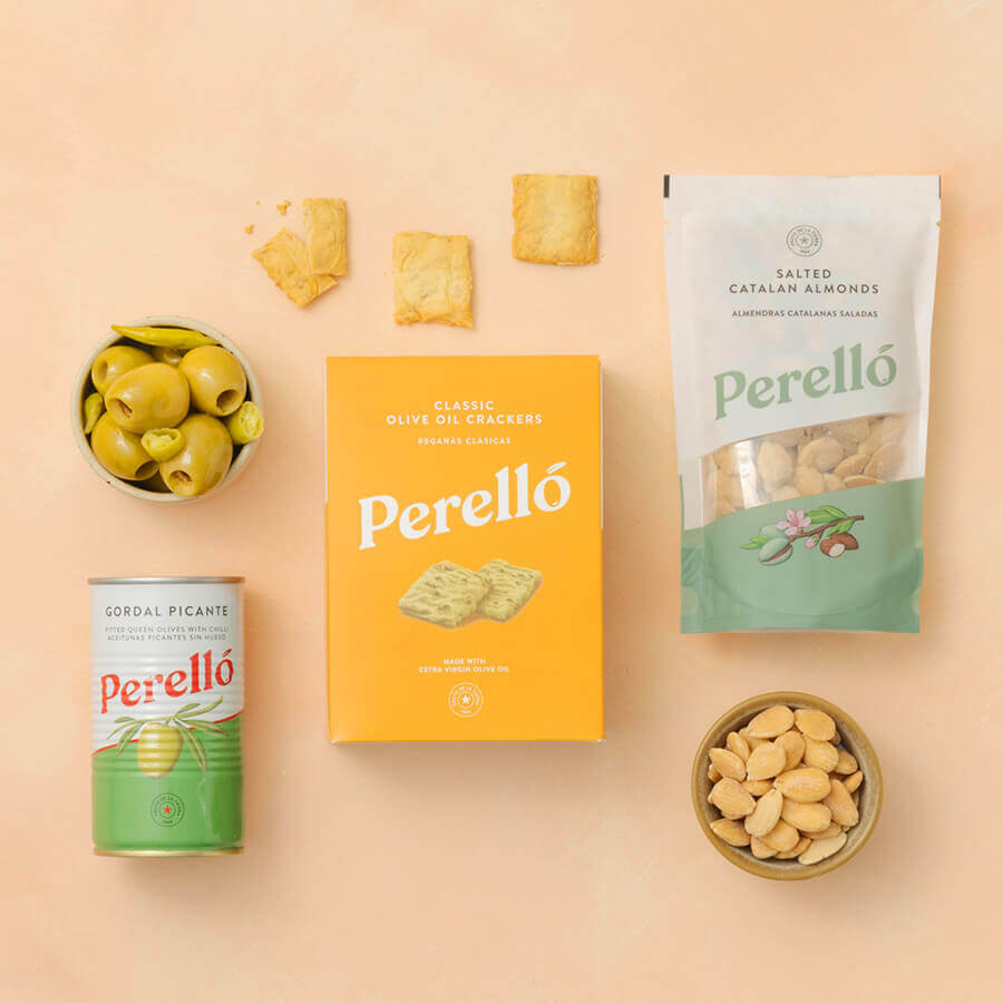 Perello brand products including a Perelló gordal tin, cracker box, and packaging on a beige background