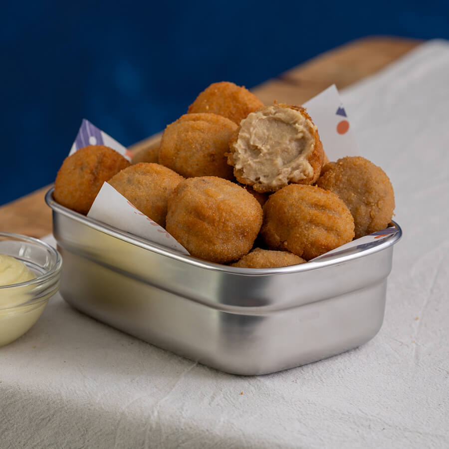 Metallic container filled with fried mushroom croquetas