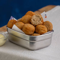 Metallic container filled with fried mushroom croquetas