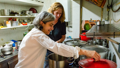 two women cooking beans