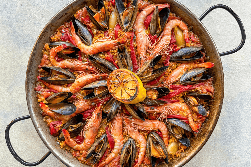 Seafood paella served on a paella pan 