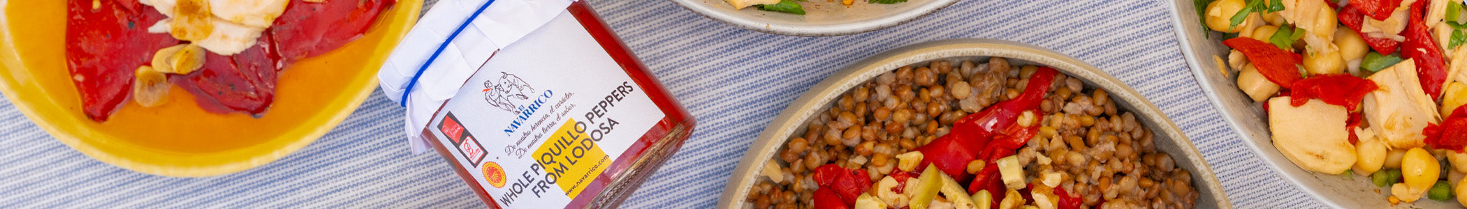 Spanish Piquillo Peppers in a jar and various salads including those peppers 