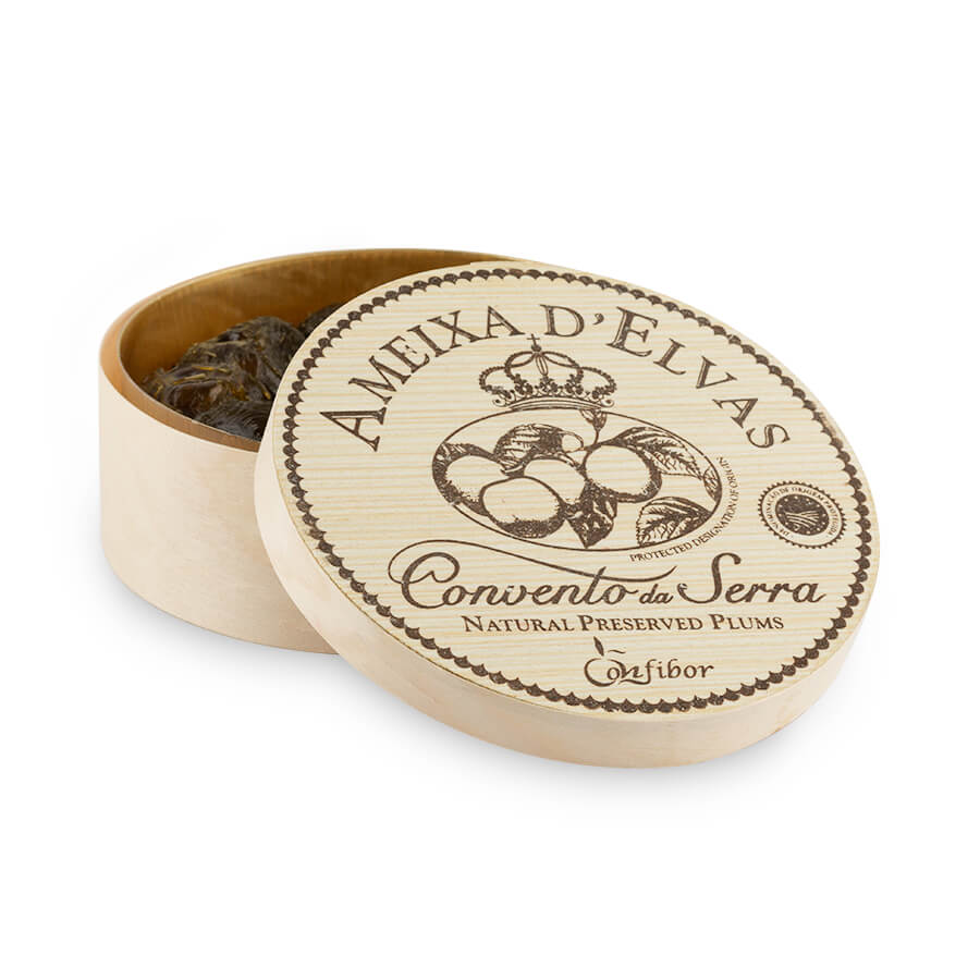 an open wooden box of preserved plums in a white background 