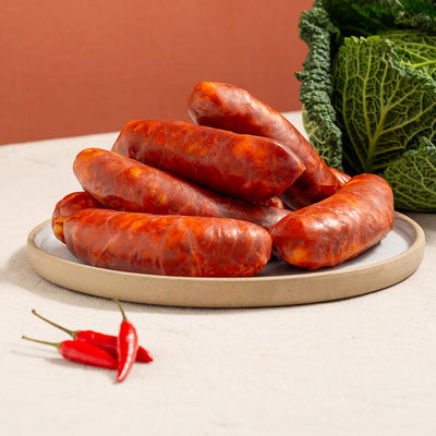 hot cooking chorizo in a plate, three chillies and a savoy cabbage