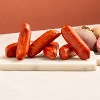 chorizo sausages on a marble board, vibrant red and two candy beetroot 