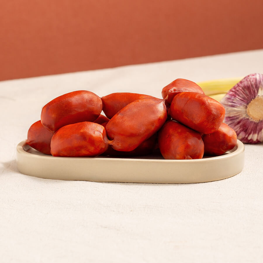 brindisa mini chorizos in a tray and garlic heads