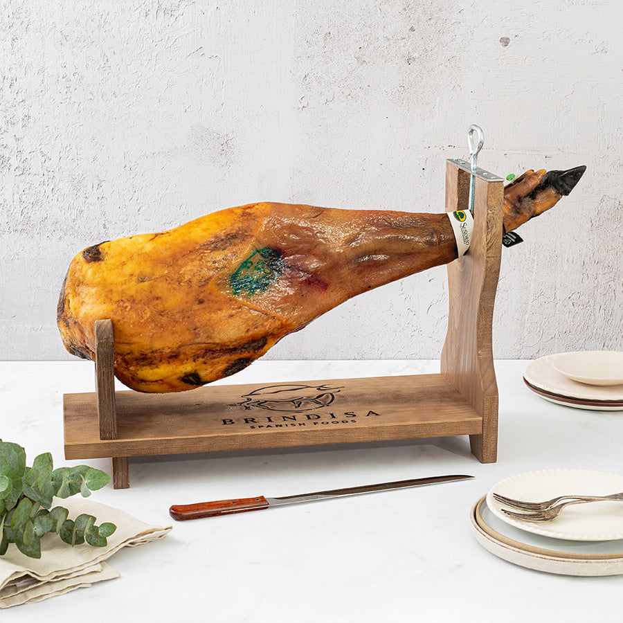 Senorio iberico shoulder on a ham stand with some eucalyptus and plates around 