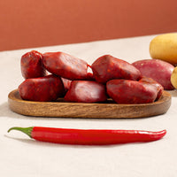 brindisa mini chorizos in a tray, potatoes and a chilly pepper