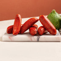 chorizo sausages on a marble board and moon courgettes