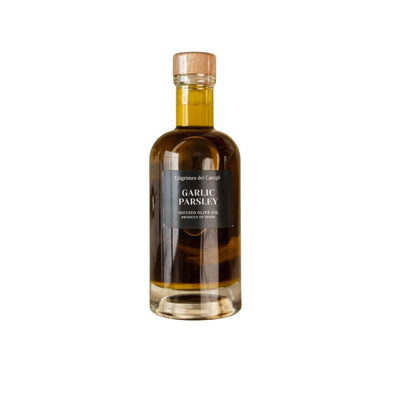 A clear glass bottle containing infused olive oil.