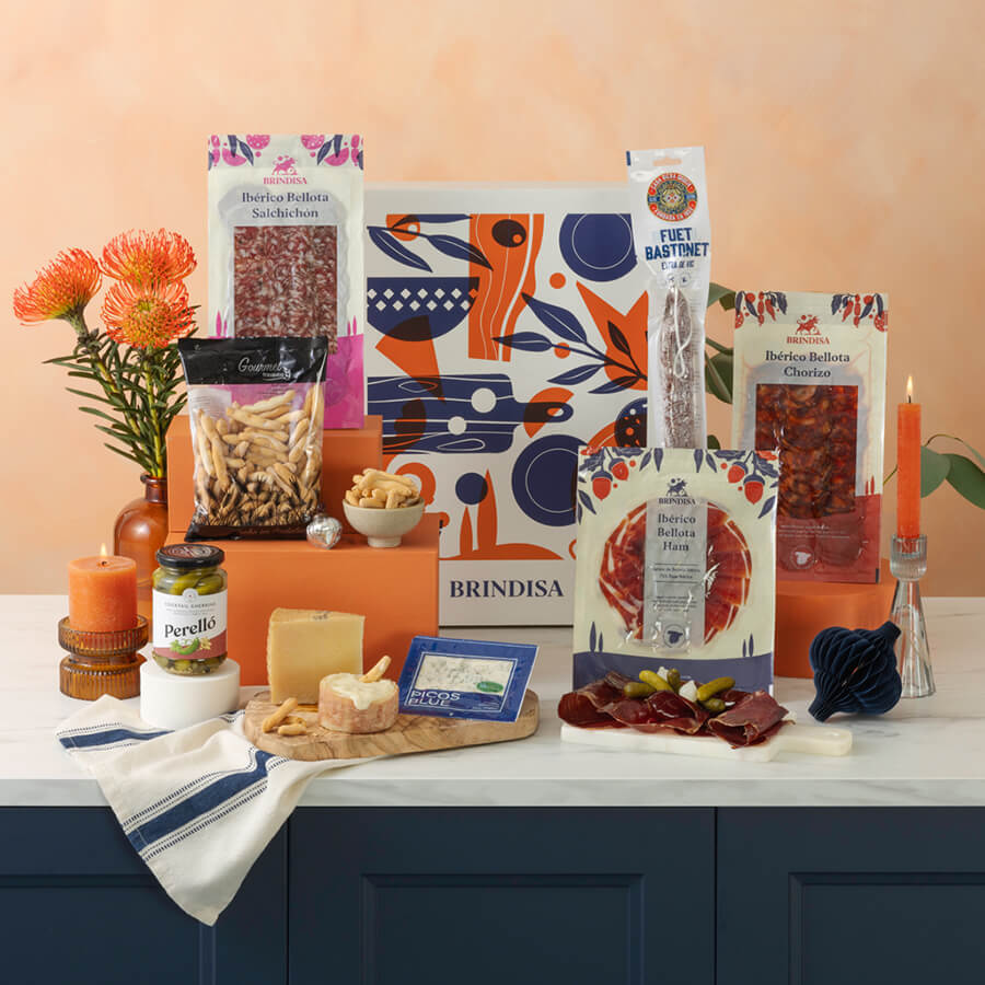 Assorted food products including meats, cheeses, and a box labeled 'Brindisa' on a countertop.