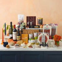 Assorted food products including wine, cheese, and snacks on a table with a neutral background