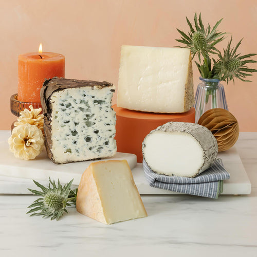 a cheese selection of valdeon blue, monte enebro, torta de barros and Villarejo Manchego on a marble board 