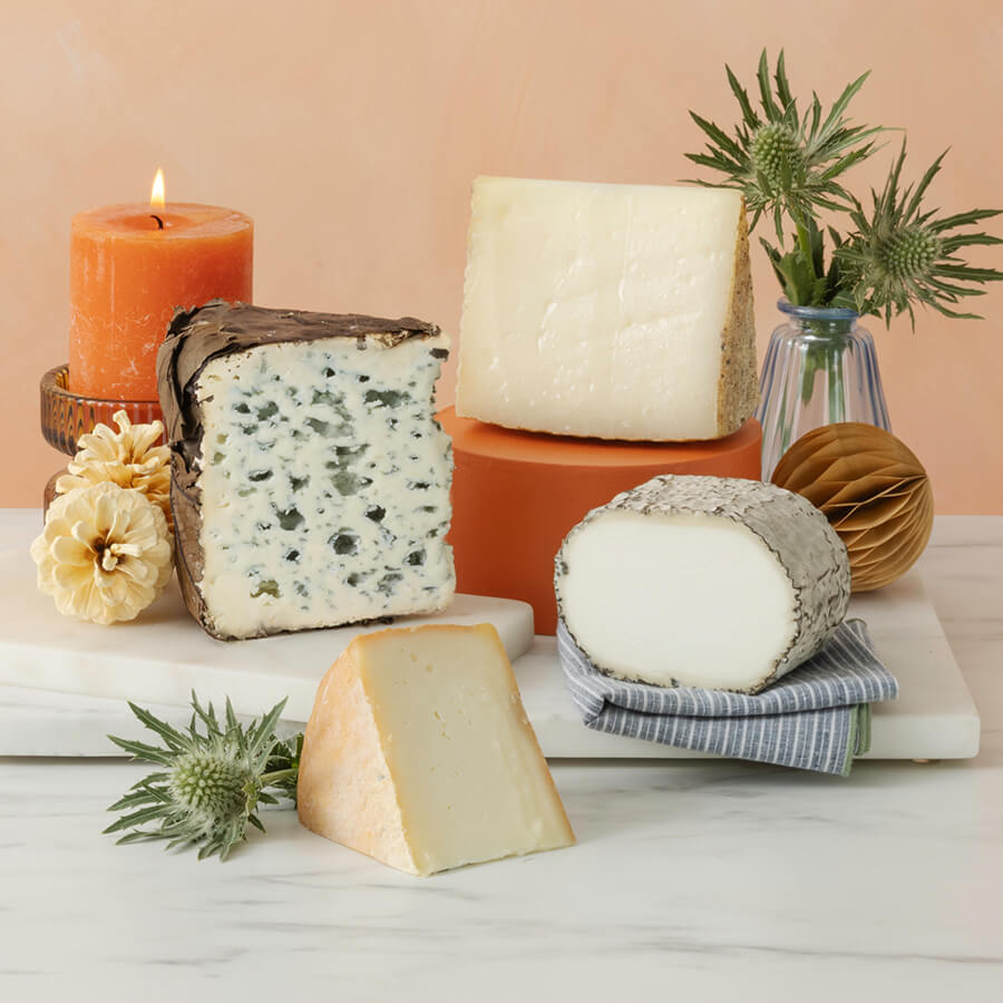 a cheese selection of valdeon blue, monte enebro, torta de barros and Villarejo Manchego on a marble board 