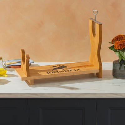 Wooden Ham Stand with 'Brindisa' branding on a kitchen counter.