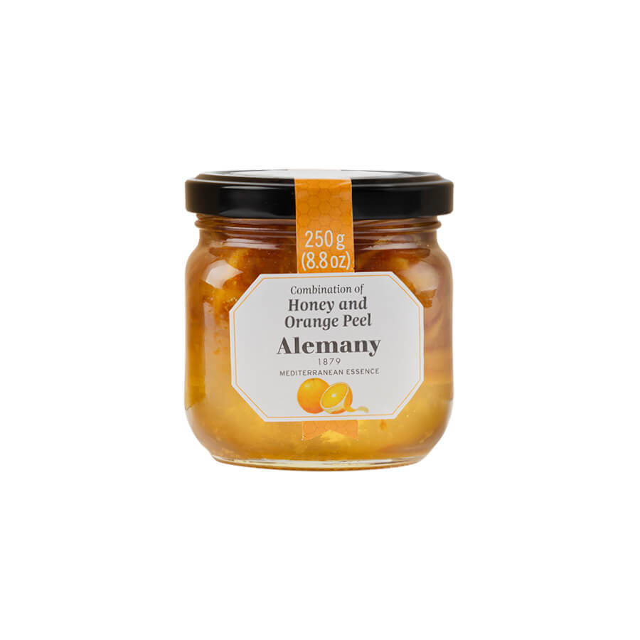 Jar of Alemany honey and orange peel on a white background