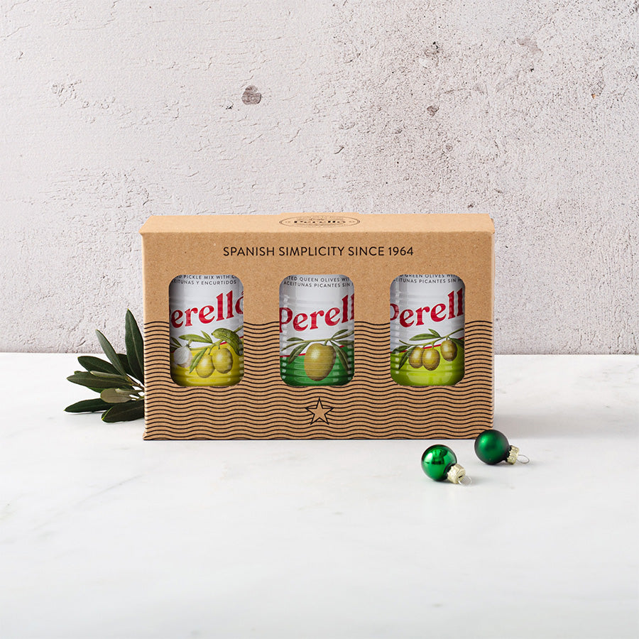 Perello olive tin selection of gordal, manzanilla and cocktail mix in a gift box decorated with Christmas green baubles and olive branches 