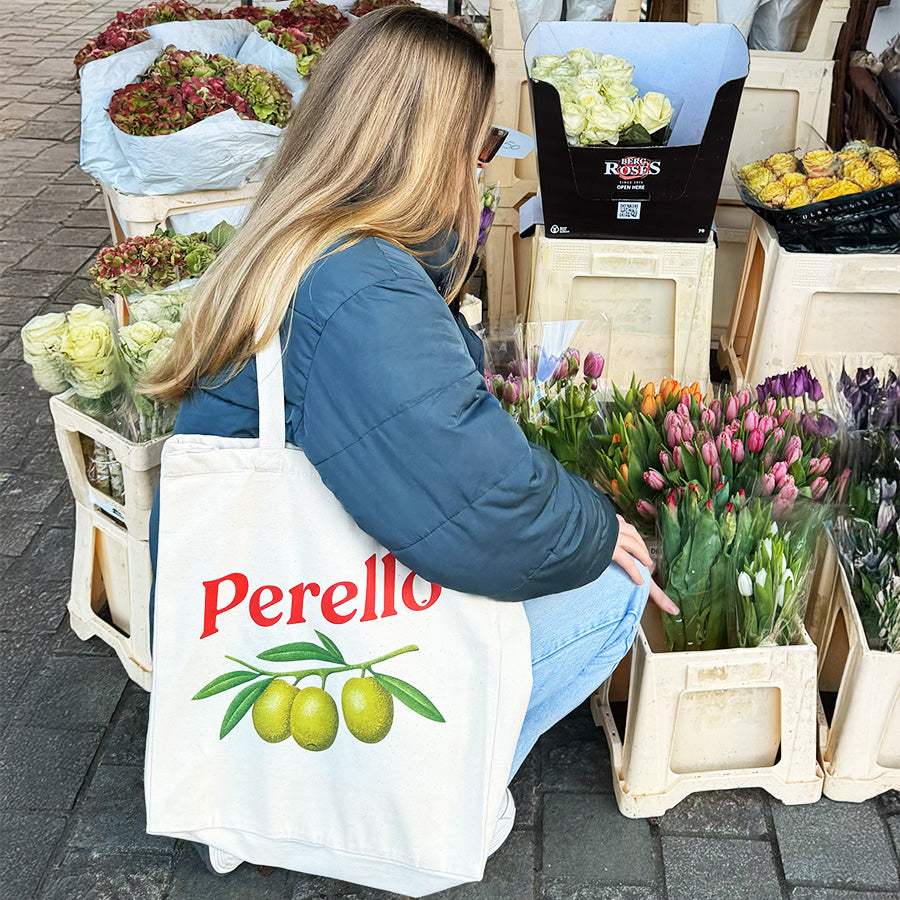 the perello tote bag hanging from a chair 