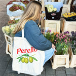 a woman wearing the Perello tote bag buying flowers