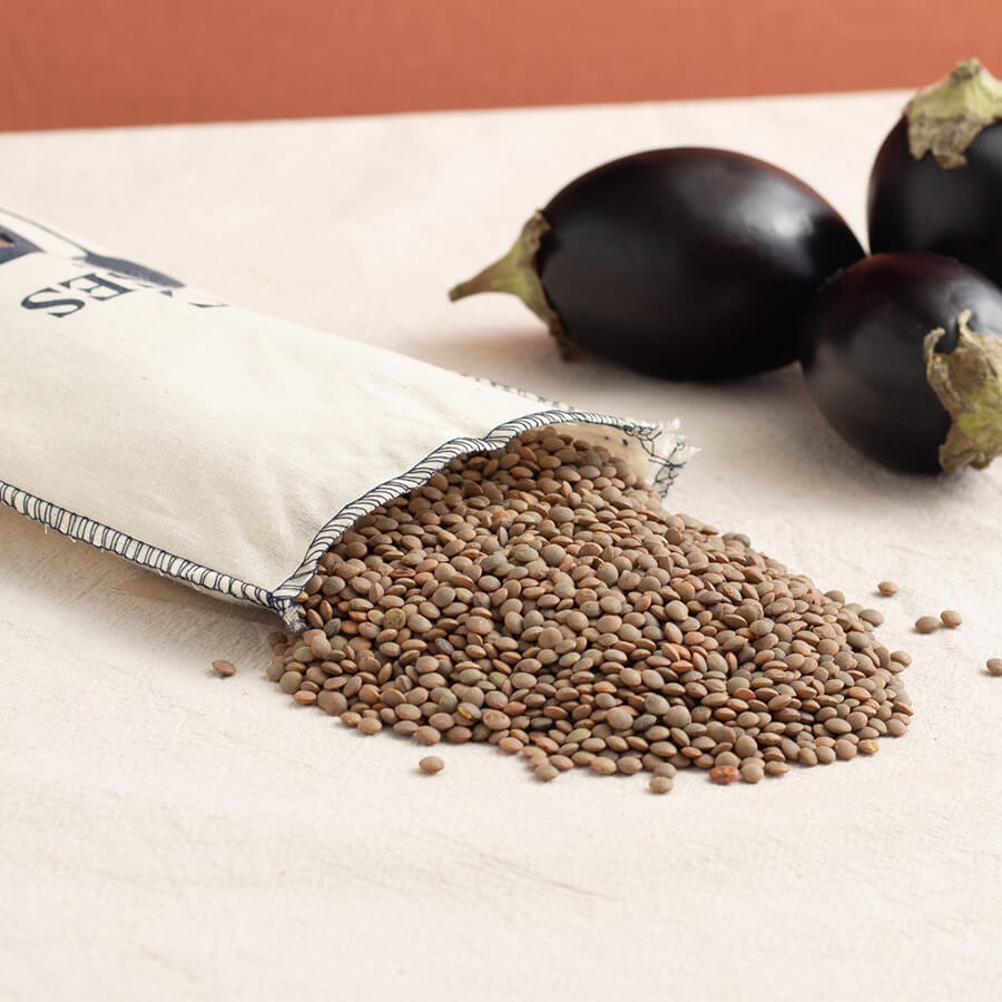LE27301 Brindisa epic pardina lentils  in a fabric sack with three aubergines brindisa spanish foods