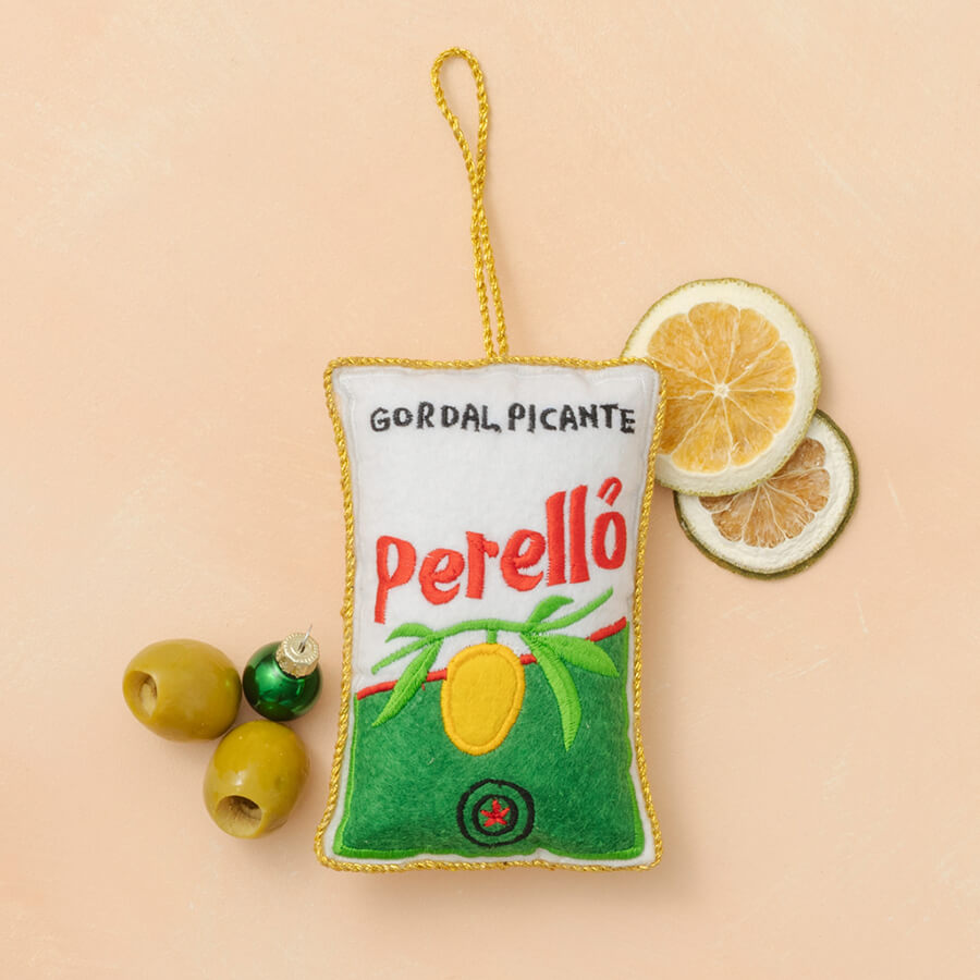 Felt product with 'Perello' branding on a beige background with lemon slices and olives.