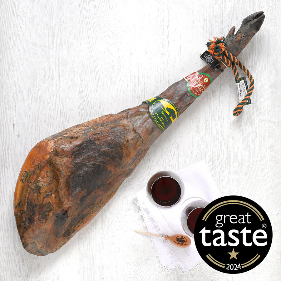 100% iberico ham in the bone with a 'Great Taste' award on a white background