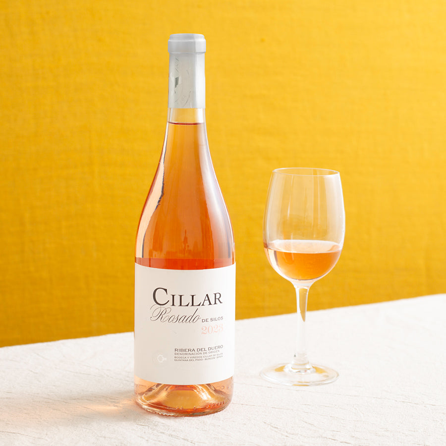 A bottle of rose wine and a glass