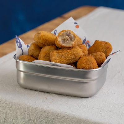 Metal container filled with fried mushroom croquetas