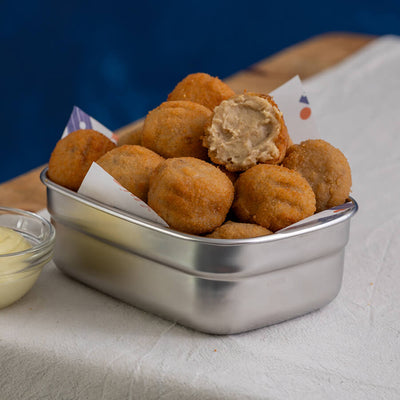 Metallic container filled with fried mushroom croquetas
