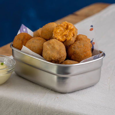 Metallic container filled with fried chorizo croquetas
